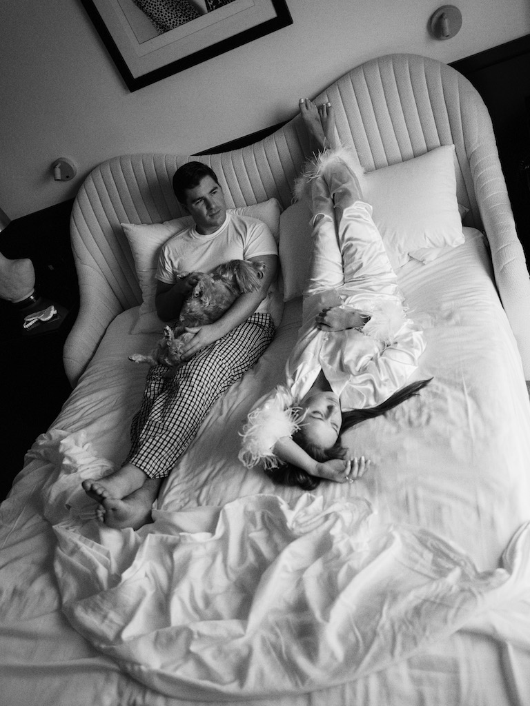 black and white photo of couple on bed before wedding